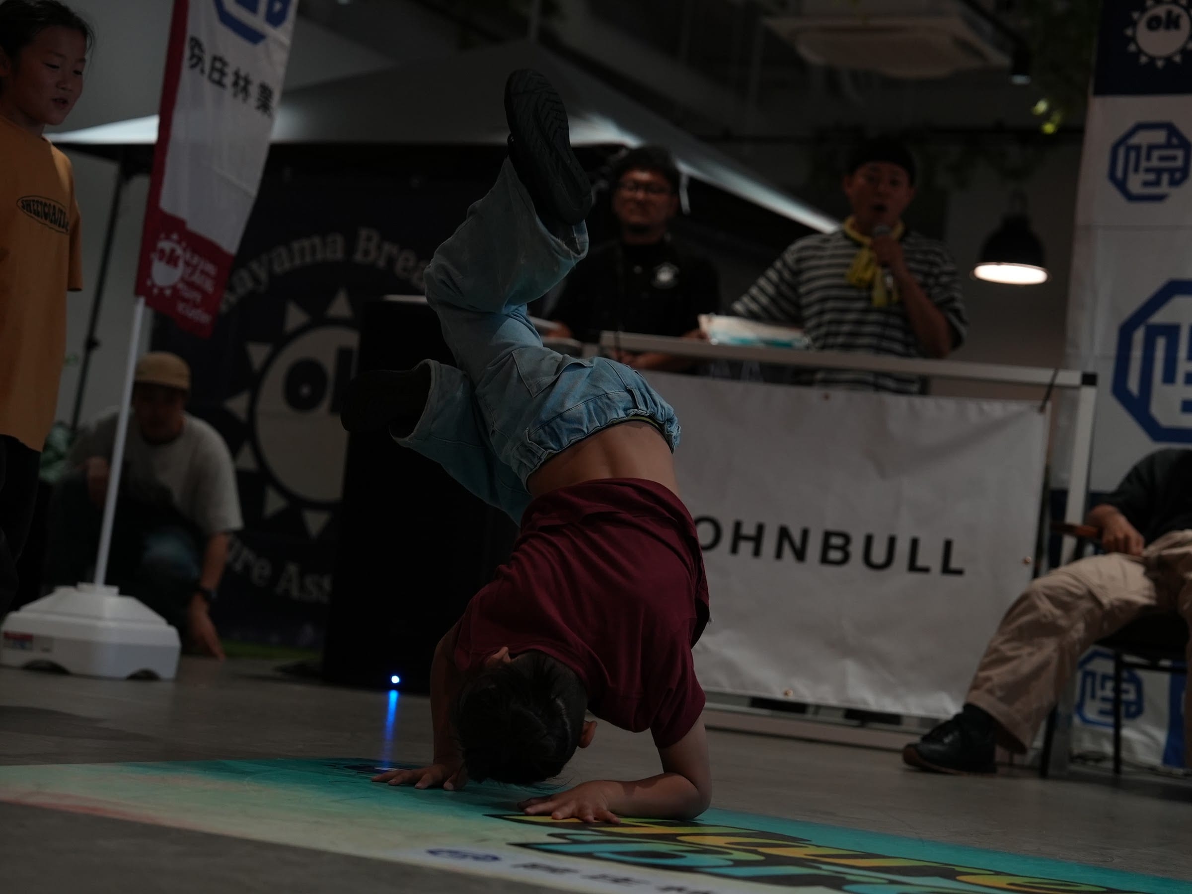 Dancer upside down with red sleeves